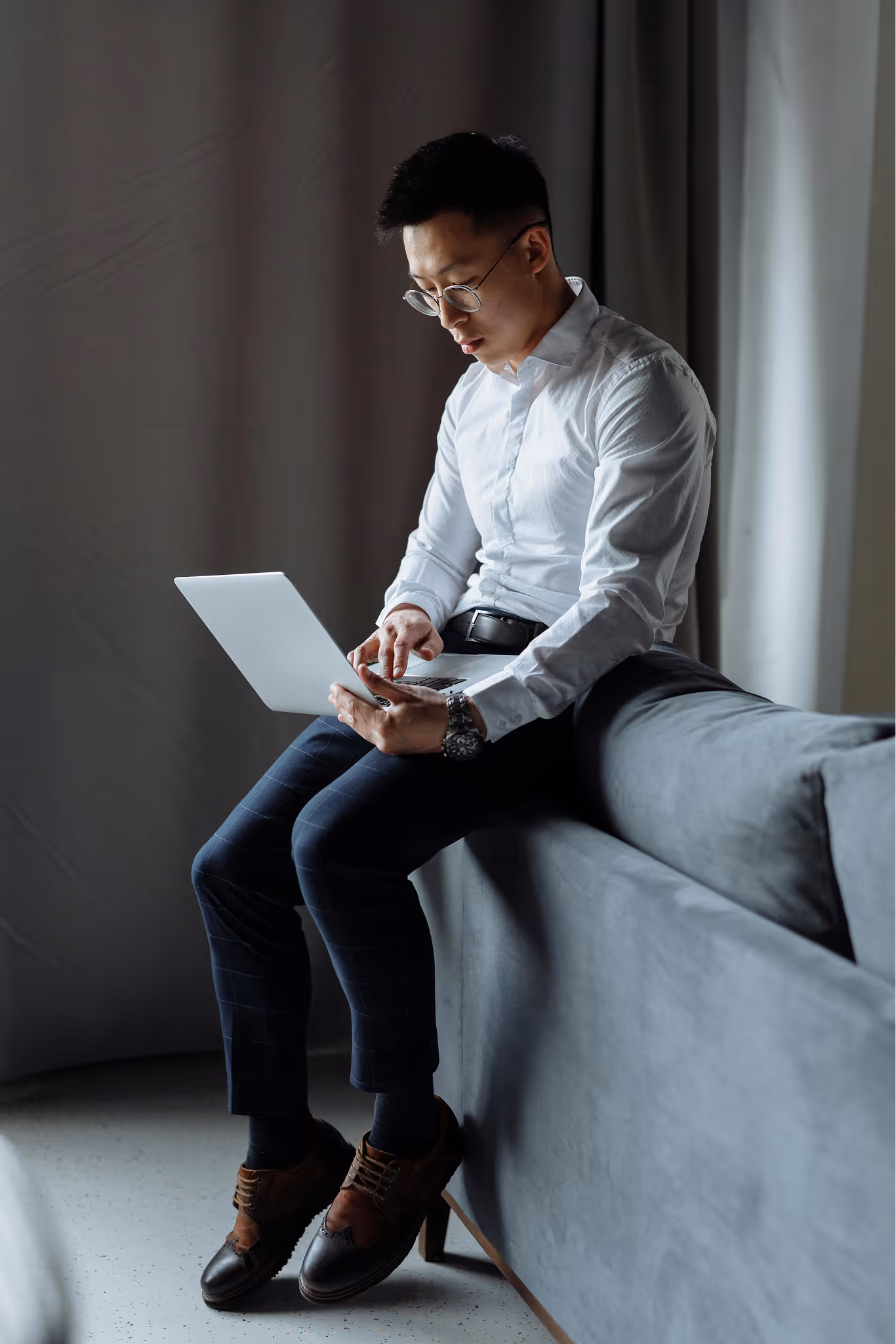 A professional reviewing work on a laptop